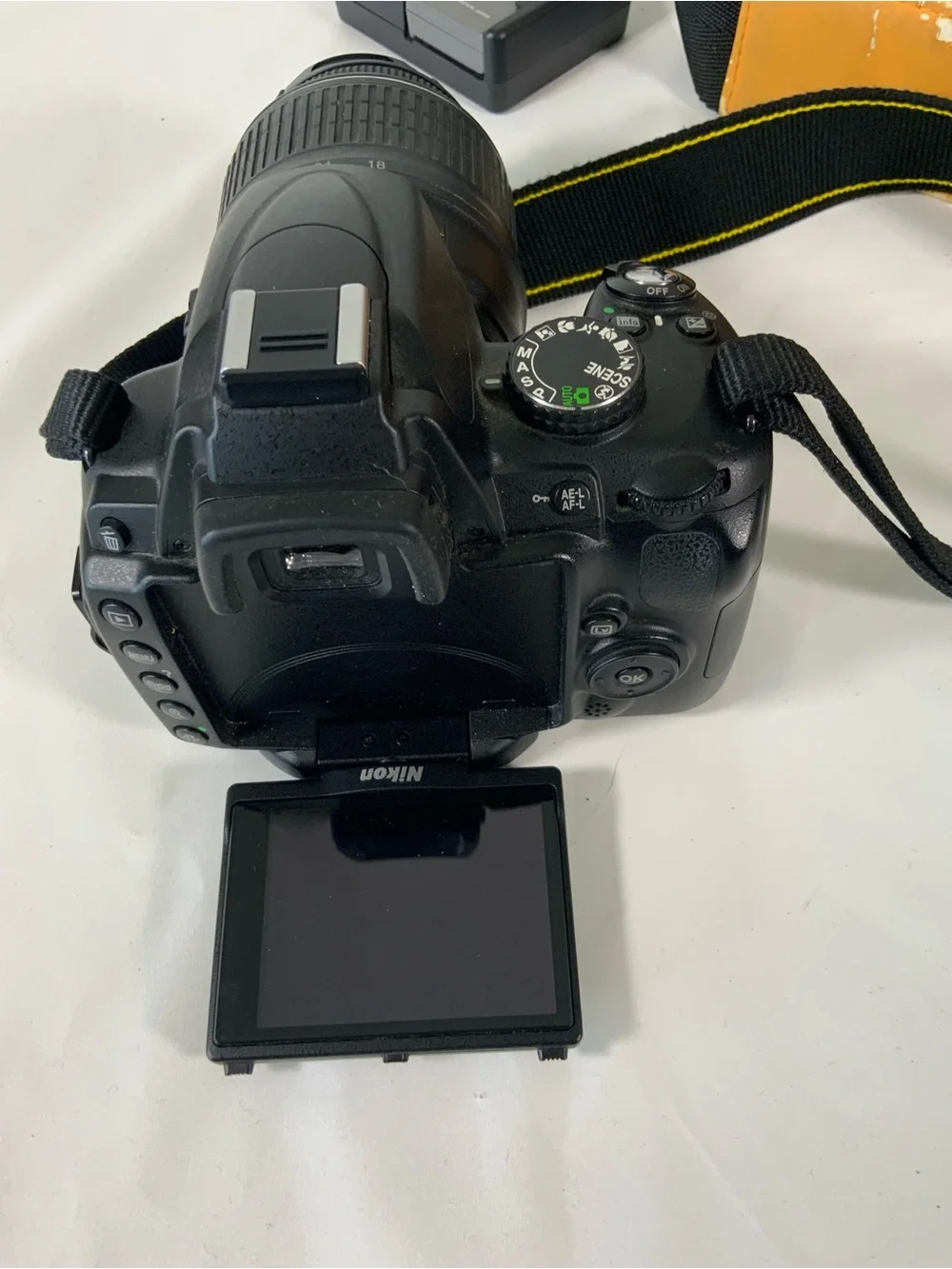 Nikon DSLR Camera with Black Body and Yellow-Orange Interior Bag